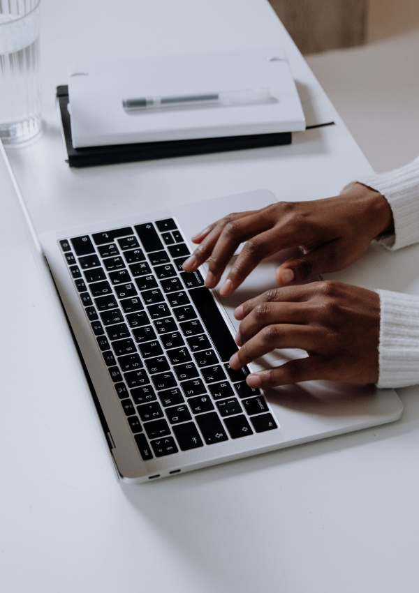 hands typing on laptop