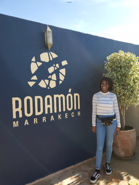 girl standing at the hostel sign in marrekesh morocco