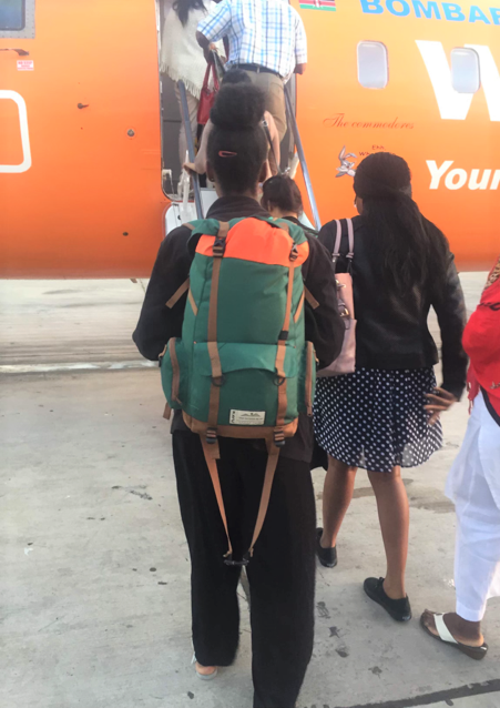 girl on plane with backpack