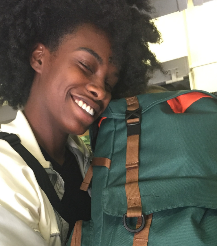 girl laying head on her backpack