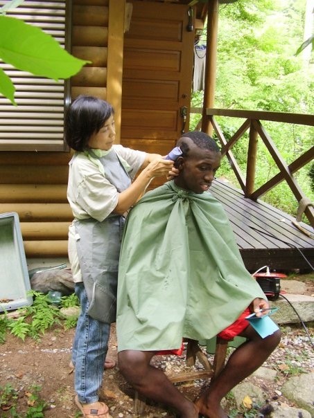 Miles getting haircut by hostmom in Japan
