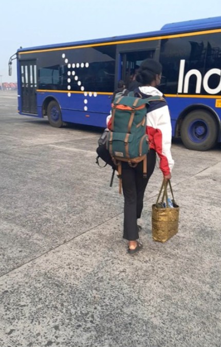 girl walking on tarmac to the airport bus
